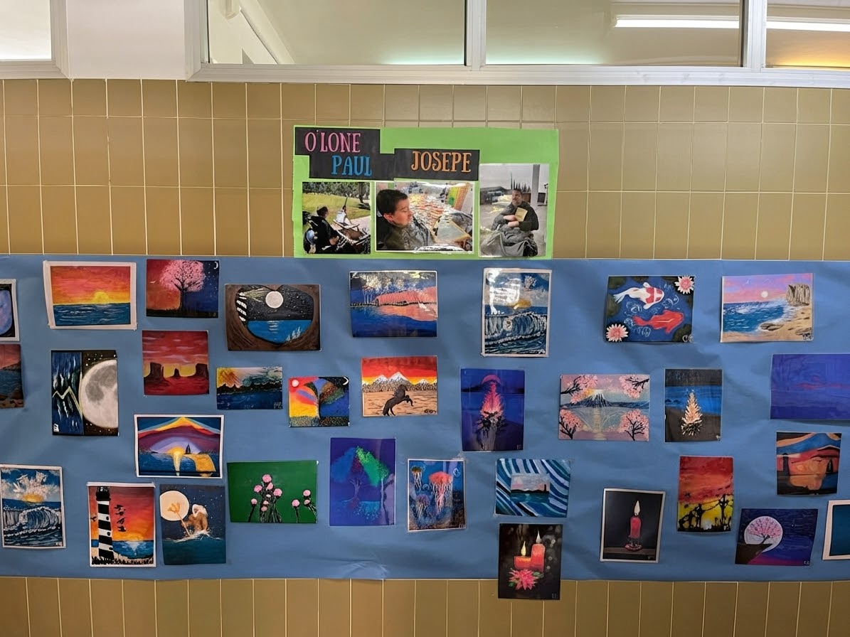Classroom in Spain displaying student mouth-painted artwork inspired by Paul O'Lone